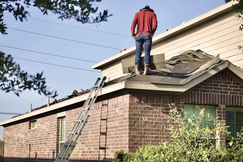 Professional roofer working on a residential roof in Willowstone